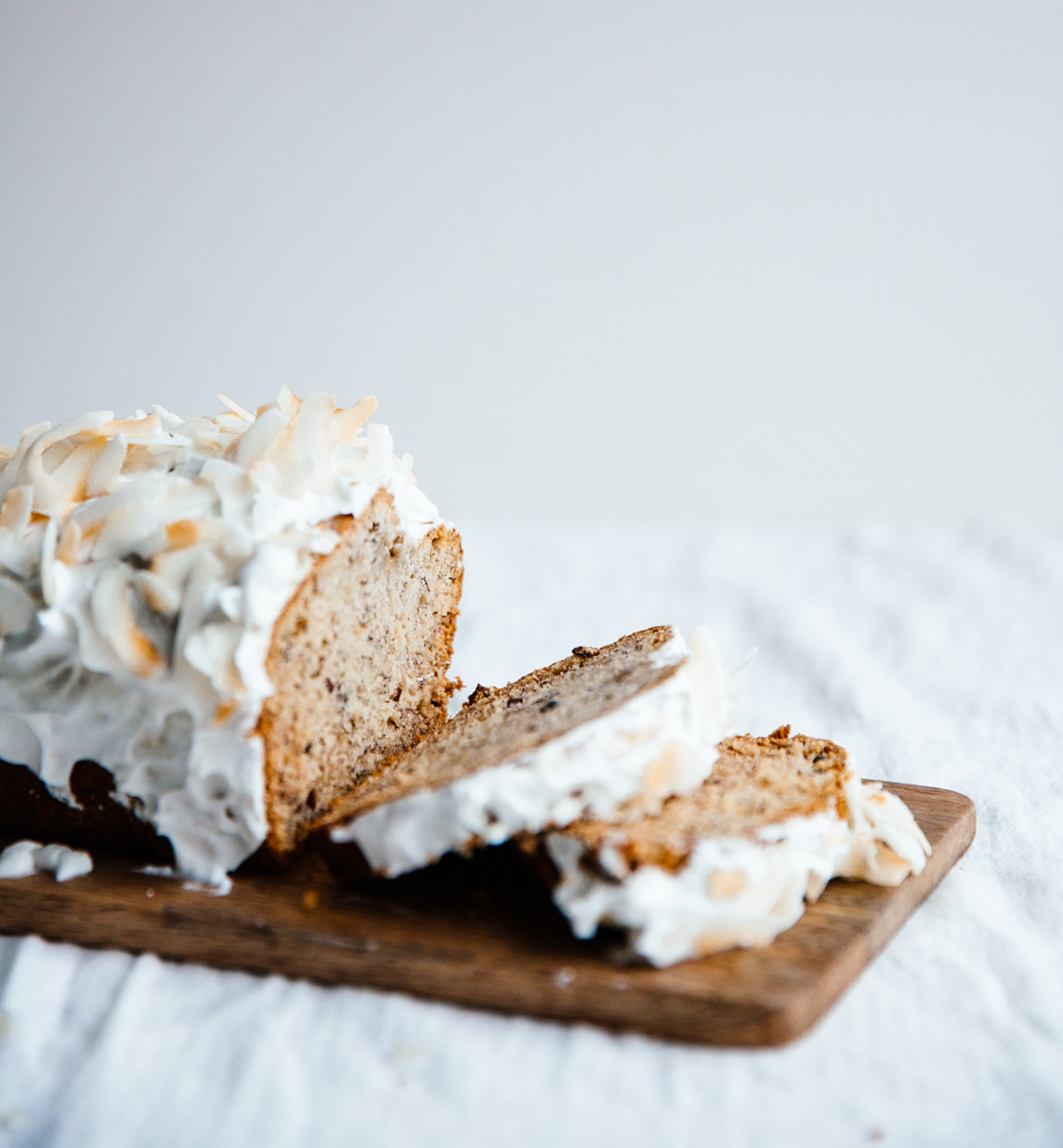 Cardamom & cocoa nib banana bread with coconut frosting