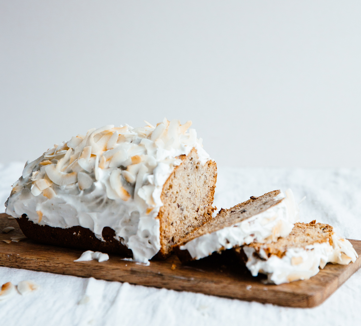 Cardamom & cocoa nib banana bread with coconut frosting