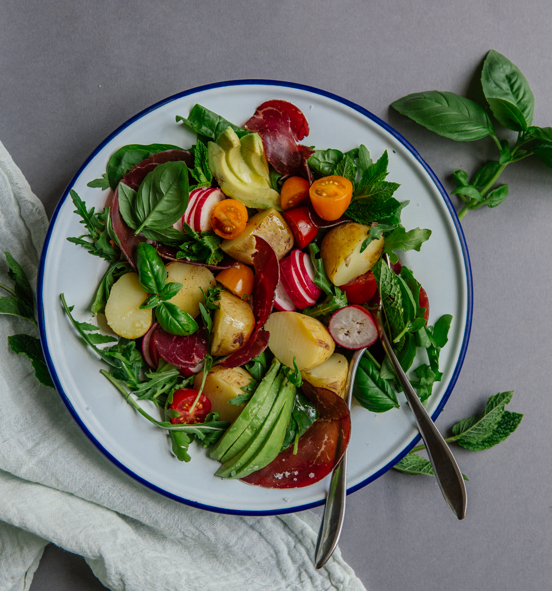 Summer potato salad with bresaola, tomatoes, radishes & avocado